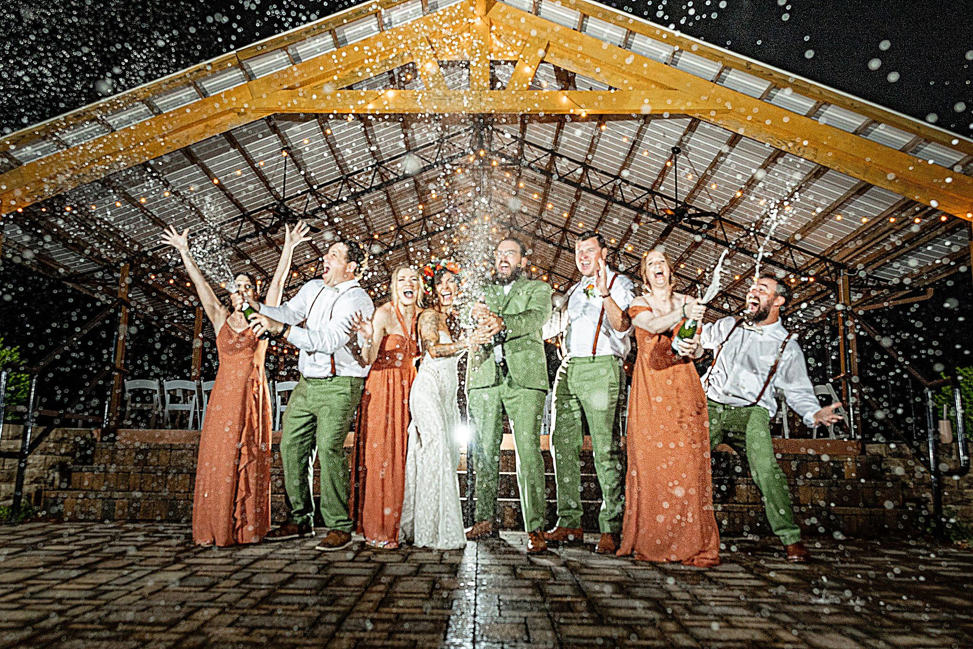 wedding party popping champagne