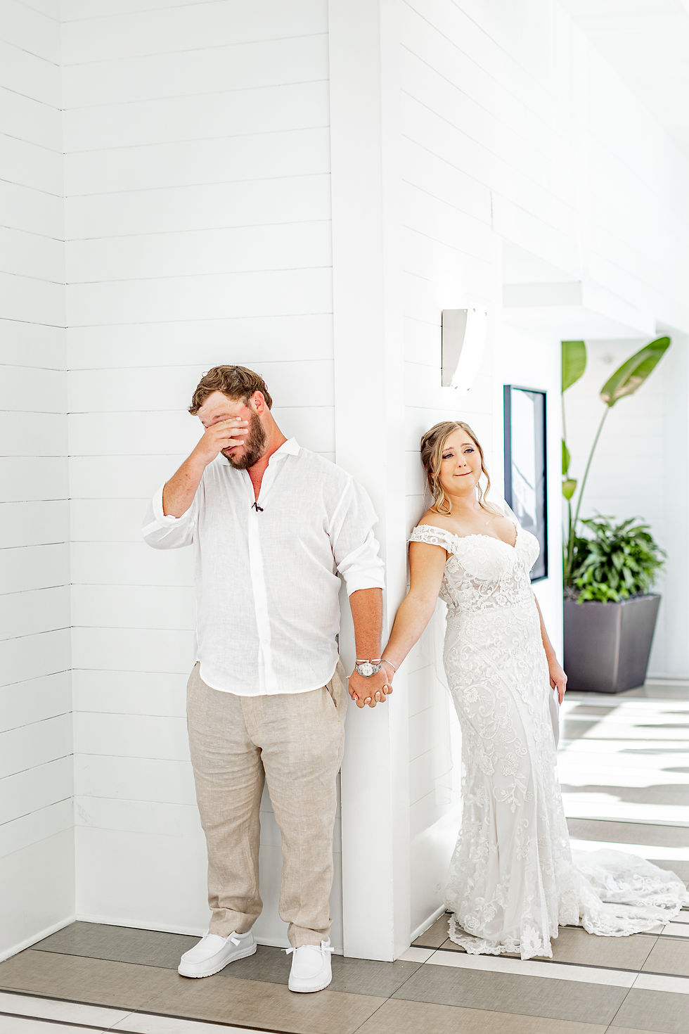 Bride and groom crying while reading letters.
