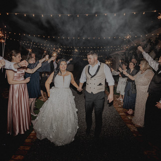 Bride and groom walking under sparklers