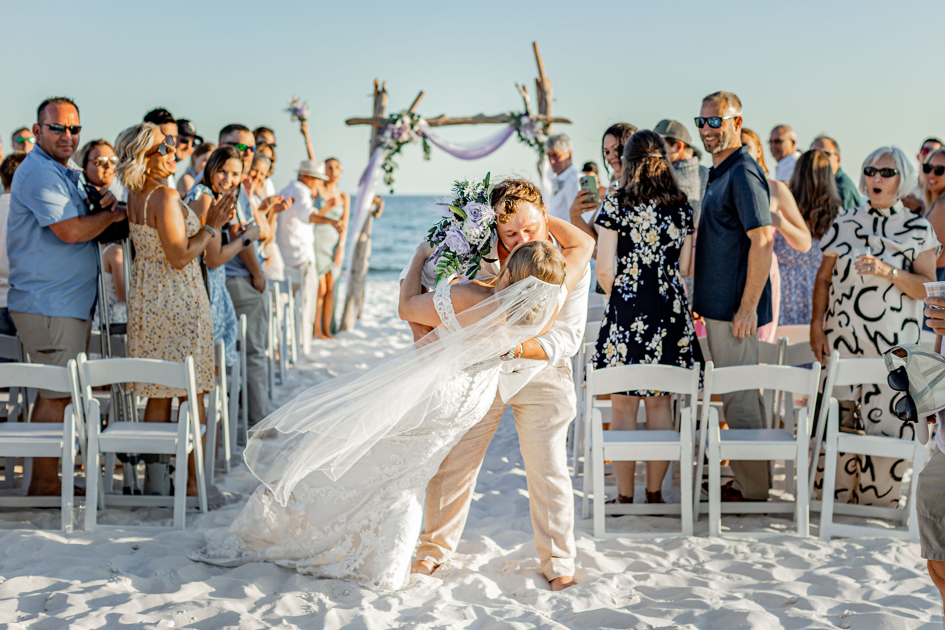 bride and groom kissing on beach