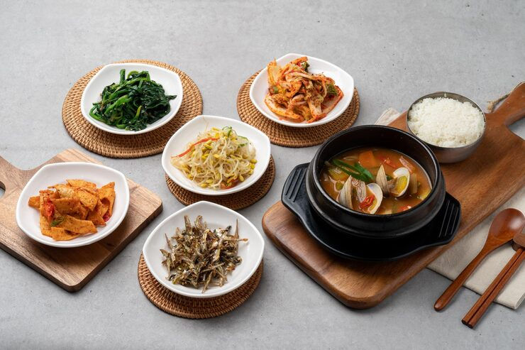 Eye-level view of a colorful Korean bibimbap bowl with fresh vegetables and rice
