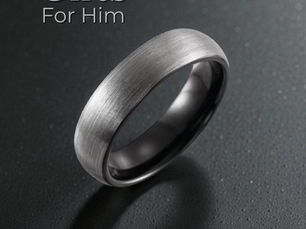 Silver ring on a dark, textured surface with "Gifts For Him" text. The mood is elegant and sophisticated.