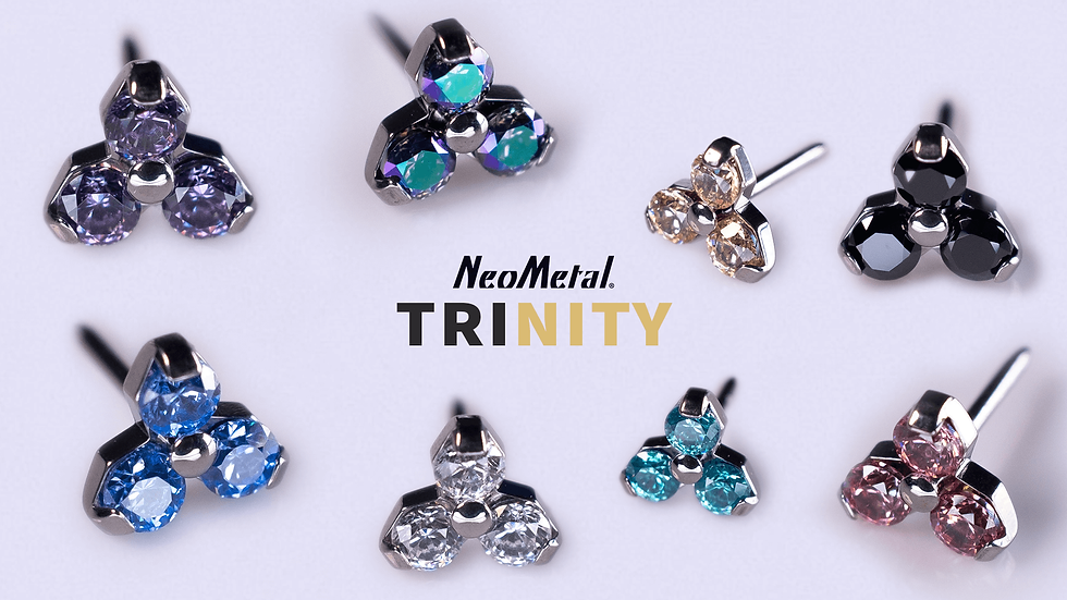 NeoMetal Trinity jewellery collection with colourful gemstones on a white background. Text: NeoMetal TRINITY. Gems in shades of blue, black, pink & white.