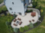 Aerial view of a custom paver patio with a fire pit.