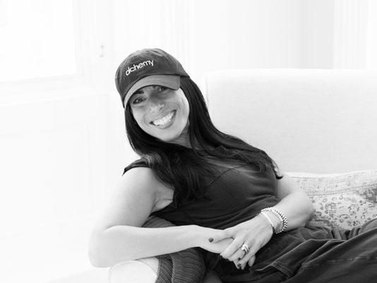 The author, Lisa Mitchell sitting in a chair and smiling