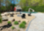 Backyard stone fire pit area with pool and pool house.