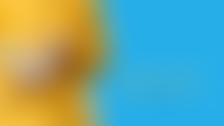 A student with a white book wearing a yellow sweatshirt standing in front of a blue background