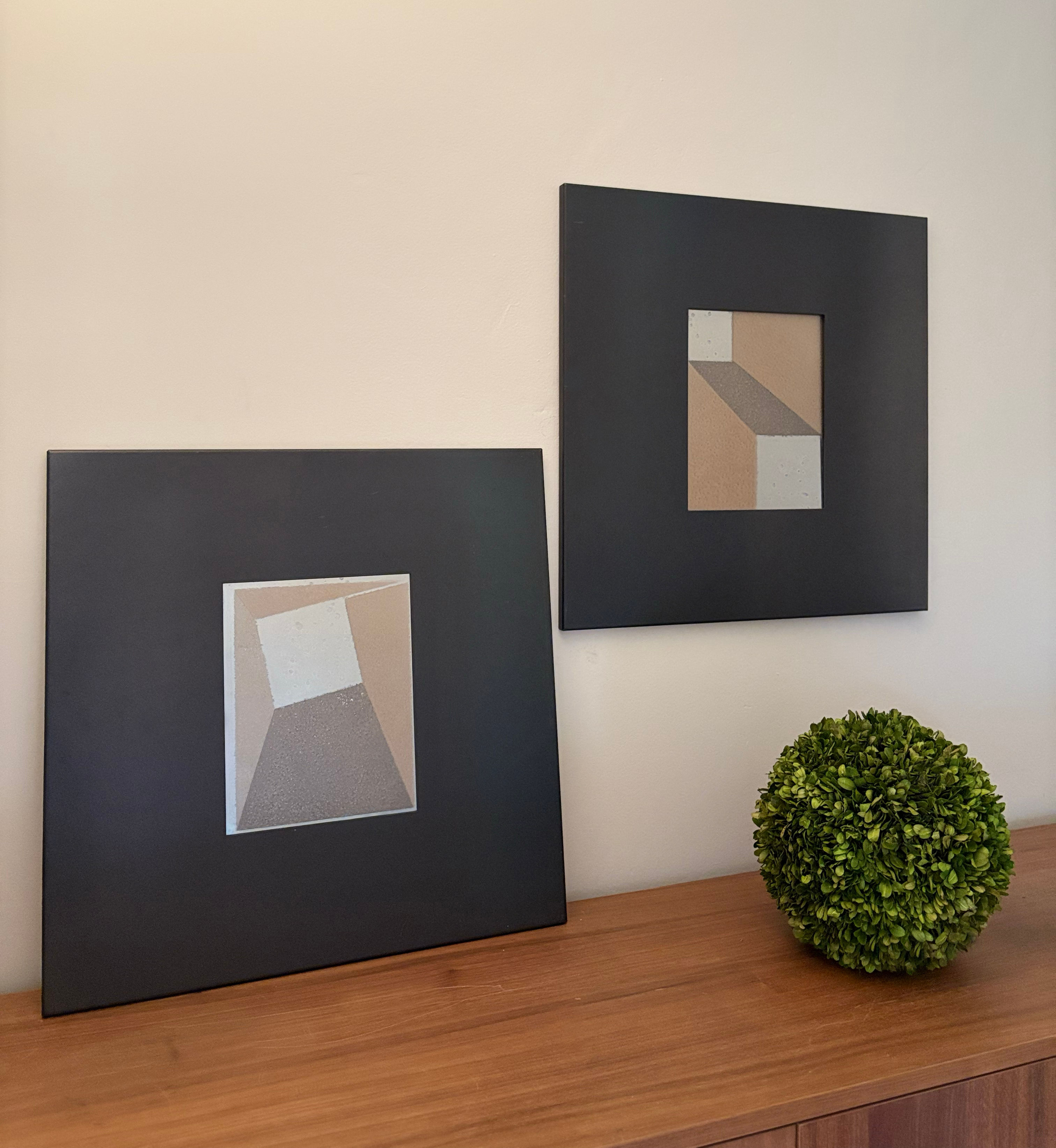 Pair of blackened steel frames with minimalist artwork