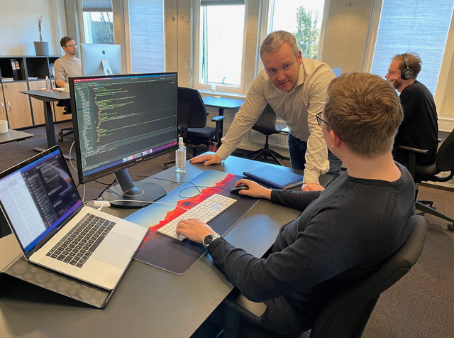 Assembly Voting CEO talking to programmer