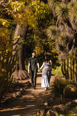 Pregnant woman standing in a garden during a professional maternity session