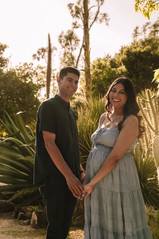 Pregnant woman standing in a garden during a professional maternity sessionity session that turns anticipation into timeless memories