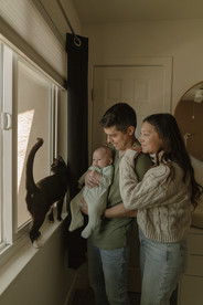 Parents and children playing and cuddling in a cozy home setting