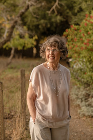Candid family moments captured outside, with natural light and greenery in the background