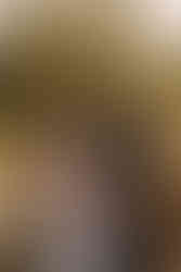 Pregnant woman standing in a garden during a professional maternity session