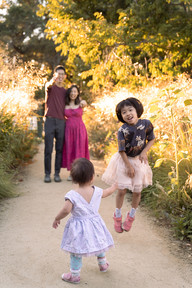 Children running and playing with their parents during an outdoor lifestyle photoshoot