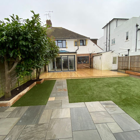 Grey sandstone paving and artificial grass