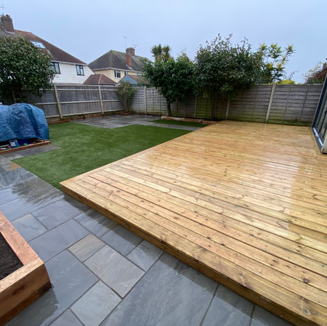 Grey sandstone paving and artificial grass