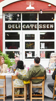 Couple enjoys a Santé Supper Club dinner in front of Cleveland's Larder Delicatessen with James Beard awarded chef, Jeremy Umansky