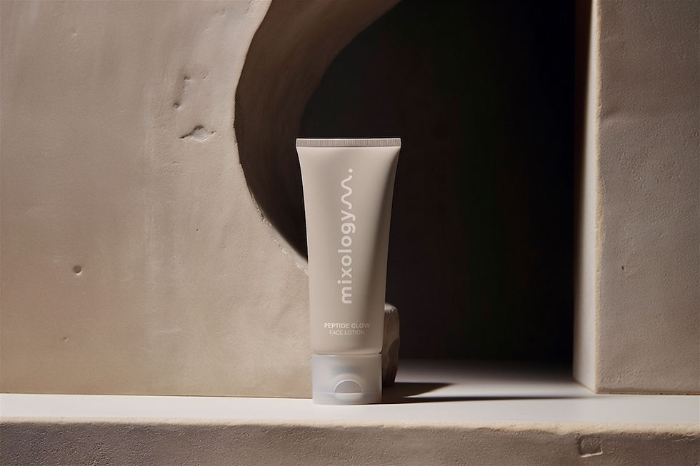 A taupe-colored bottle with the mixology logo perches on a concrete step.