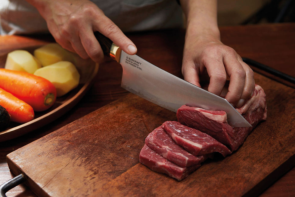 Miniaturbild: Auf einem Holzblock wird Fleisch mit dem Messer geschnitten