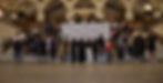 Large group of youth posing on marble stairs in an ornate hall before a Philadelphia Youth Network, Work in progress banner