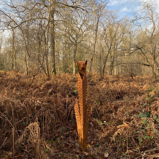 Standing cheetah corten sculpture with rust finish and integrated lighting, creating a striking focal point.