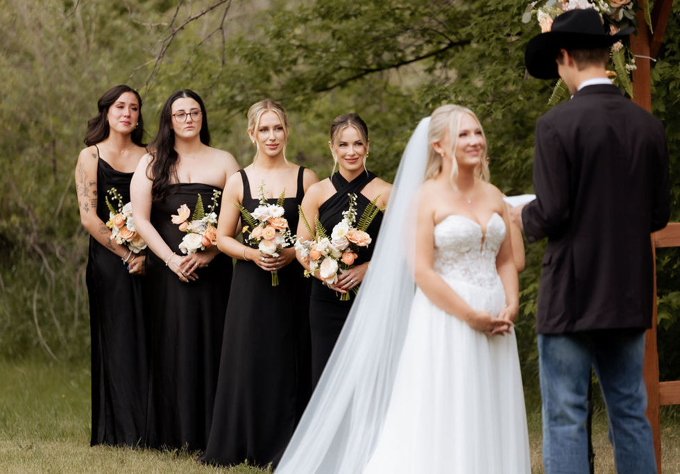Country-chic wedding ceremony decorated with soft pastel garden-style floral arrangements