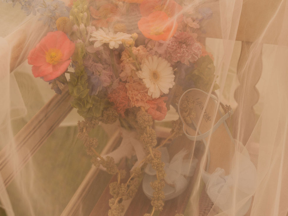 Bright eclectic bridal bouquet featuring orange, coral, pink, yellow, white and lime green flowers with playful modern movement.