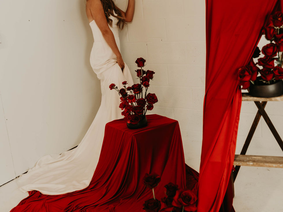 Modern red floral design influenced by Japanese Ikebana with sculptural stems, negative space, and intentional asymmetry