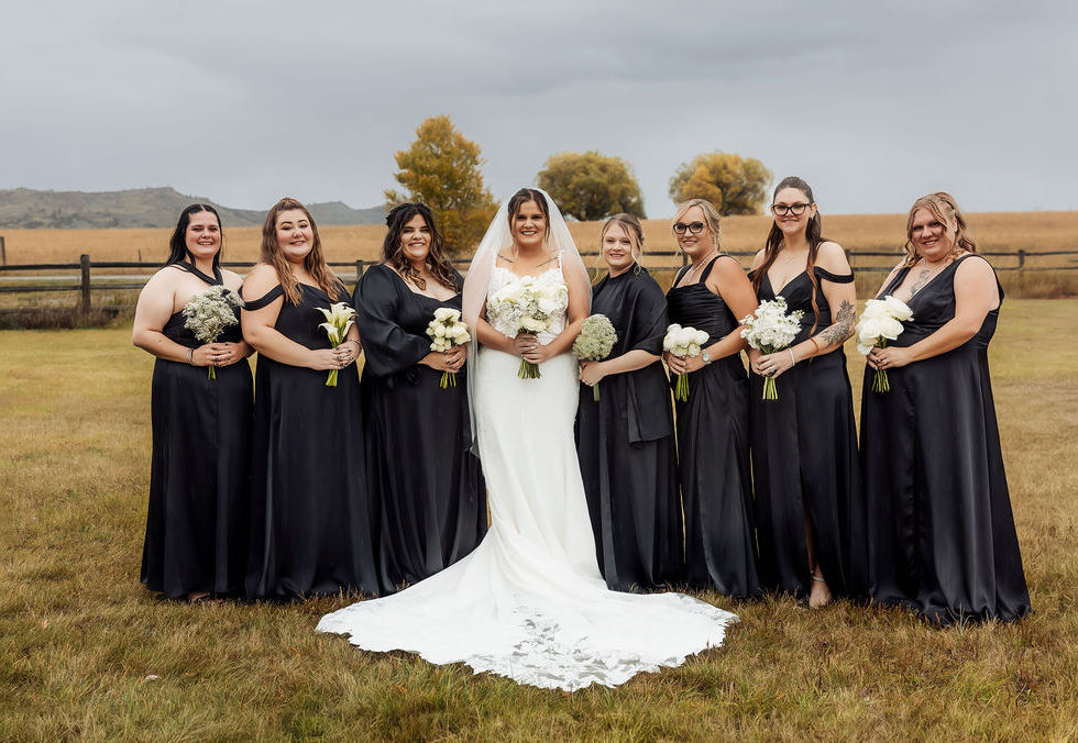ride and bridesmaids holding all-white bouquets with organic movement and modern garden-inspired floral design