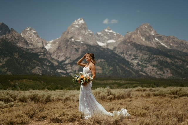 Lush bridal bouquet with green, white, peach, yellow, and blue flowers designed for a romantic elopement in the Tetons, Bridal