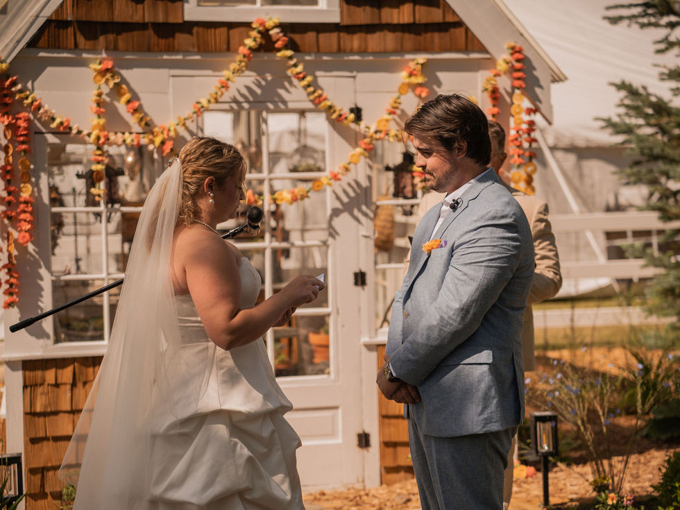 Bright eclectic wedding ceremony featuring playful orange, coral, pink, yellow, white and lime green floral installations
