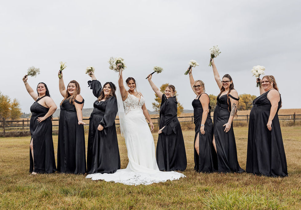 ride and bridesmaids holding all-white bouquets with organic movement and modern garden-inspired floral design