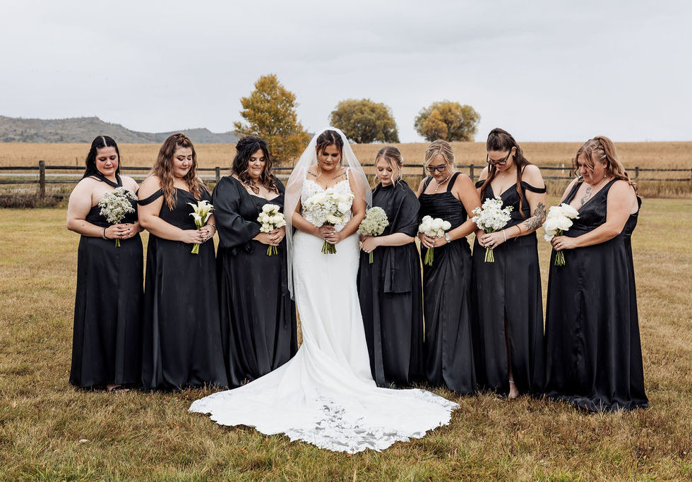 ride and bridesmaids holding all-white bouquets with organic movement and modern garden-inspired floral design