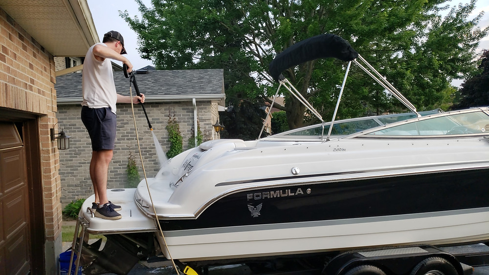 Boat on trailer in driveway
