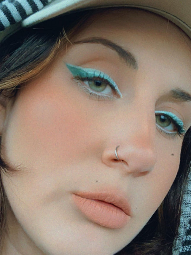 Woman with blue eyeliner and hat. EJS Beauty. Close-up face portrait