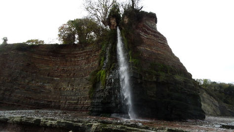 This is the magical hidden beach where waterfalls tumble down dramatic cliffs