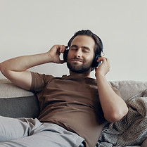 handsome-young-man-adjusting-his-headphones-while-2022-09-29-20-07-00-utc.jpg