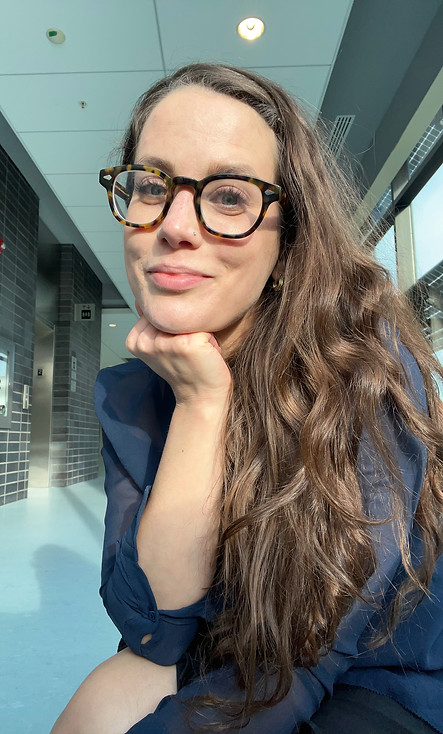 Headshot of a white women with long brown hair and glasses
