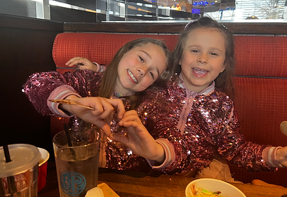 Vivi and Bella sitting in a restaurant