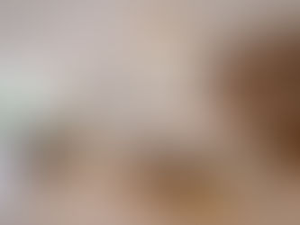 High-end modern kitchen makeover featuring marble waterfall island, warm wood cabinetry, and pendant lighting in a luxury Charlotte home