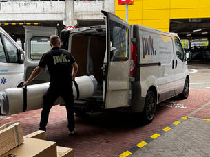 Man loading a mattrass into van