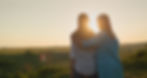 Mom hugs her teenage daughter, watching the sunset over a picturesque valley. Back view.jp