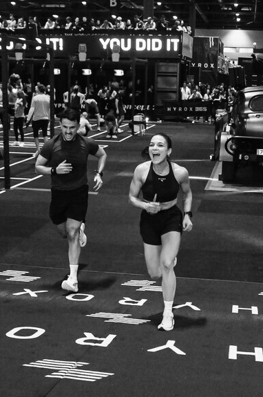 Crossing the finish line at a HYROX event, in black and white