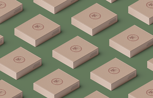 Beige boxes with logo, Kalaa, on green background