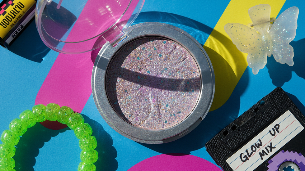 Close-up view of a shimmering highlighter product in a compact case
