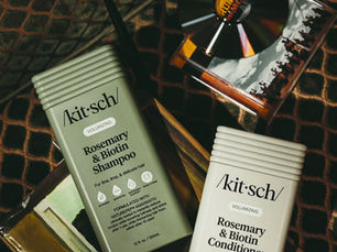 '90s rockstar energy meets shampoo bottles. Red wine, a drumstick bookmark, and two very confident products glowing like they own the stage.