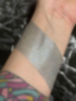 Silver eyeshadow swatch on wrist. Mourning Serum - 7% Copper Tripeptide and Hyaluronic Acid