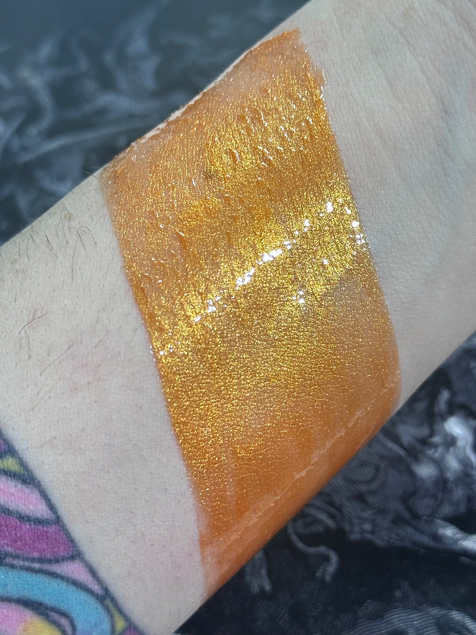 Thumbnail: Swatched orange eyeshadow on wrist, showcasing color and metallic shimmer.