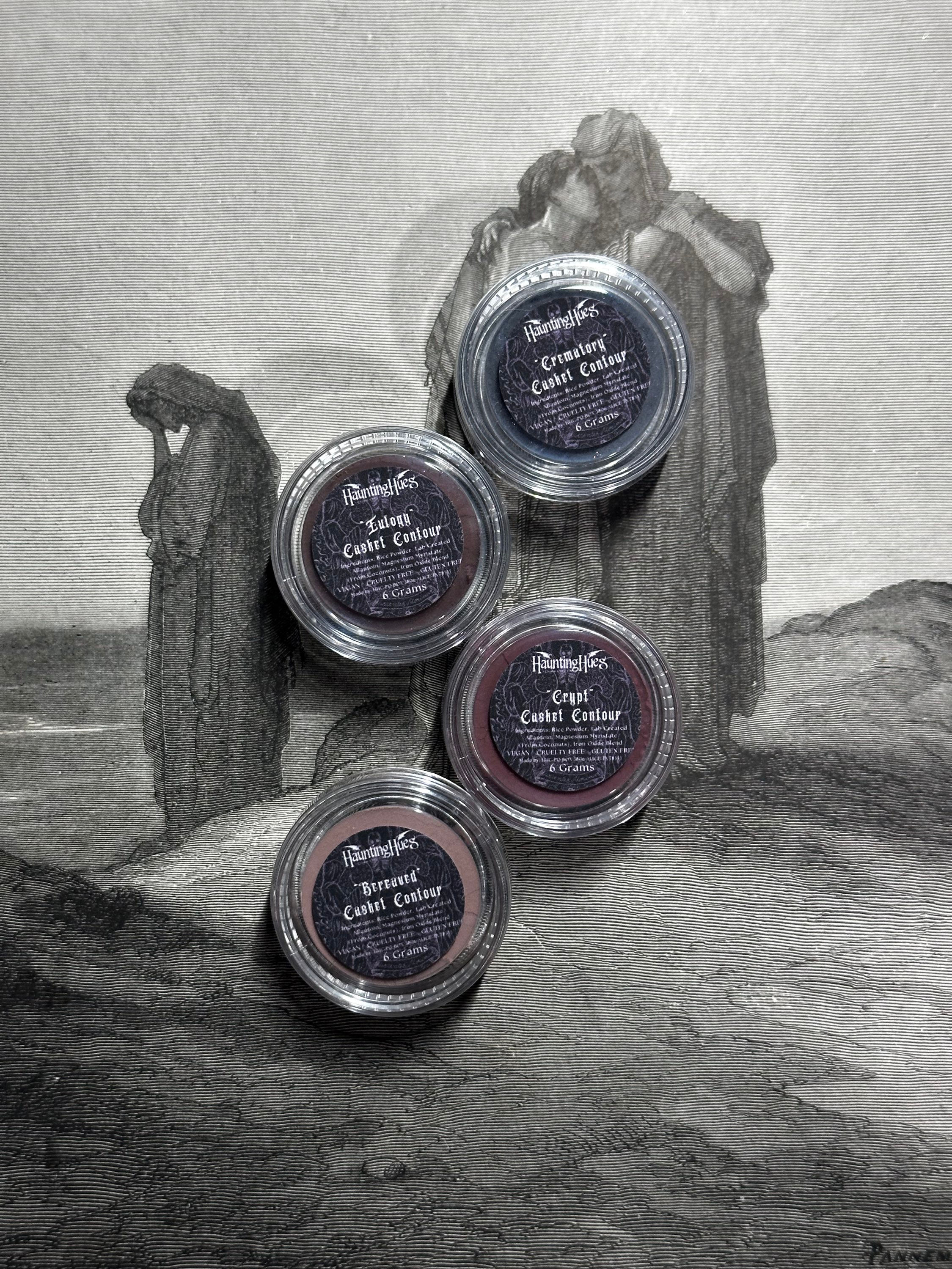 Four eye shadow pots labeled 